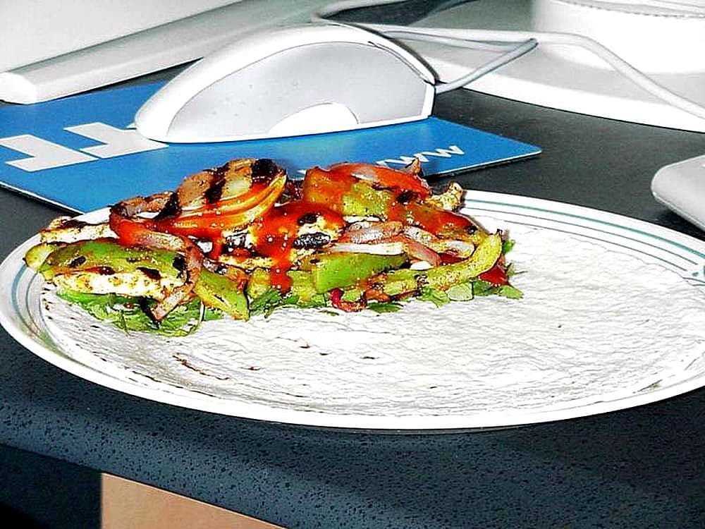 Sizzling chicken fajitas with peppers and tortillas