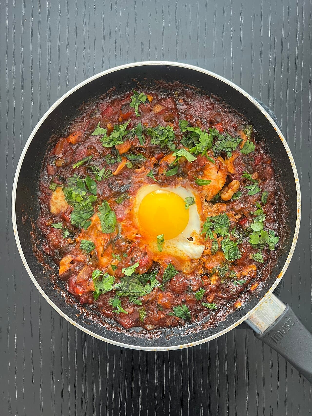 Shakshuka - eggs poached in spiced tomato sauce in a pan