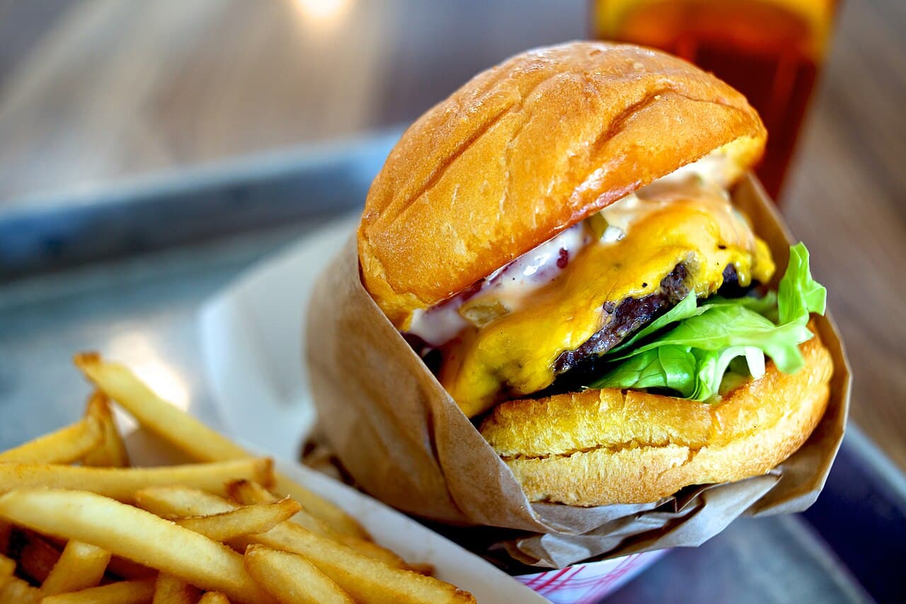 Double smash burger with melted cheese in a brioche bun