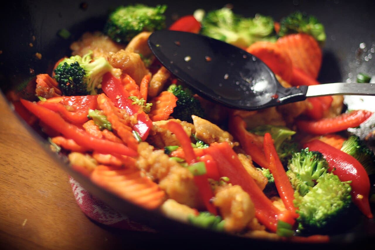 Chicken and cashew stir-fry with vegetables in a wok