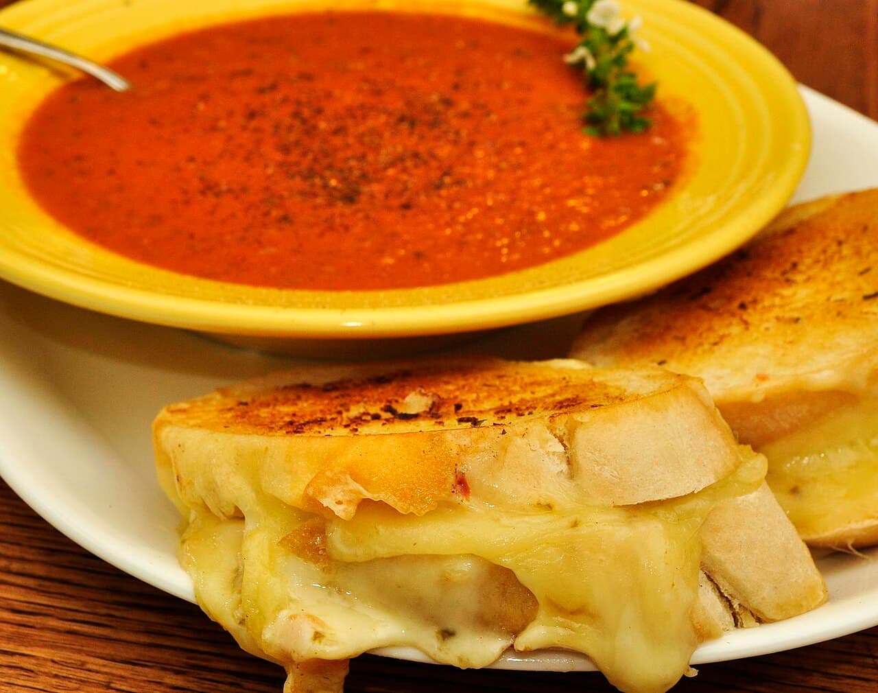 Bowl of tomato soup with a toasted cheese sandwich